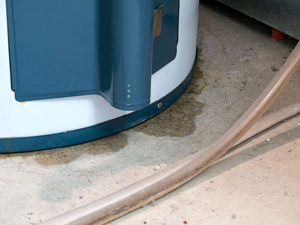AirPoint technician inspecting a water heater for leaks.