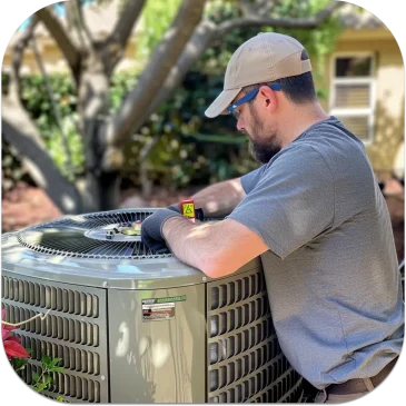 AirPoint technician servicing a Carrier AC Infinity® Variable-Speed Central Air Conditioner in a Toronto residence, focusing on efficiency and reliability.